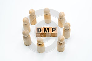 Wooden figures as business team in circle around acronym DMP Data Management Platform