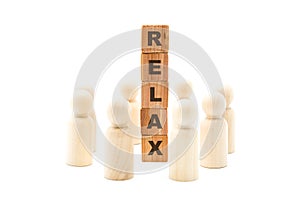 Wooden figures as business team in circle around word RELAX