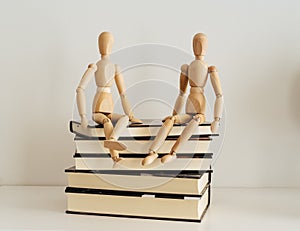 Wooden figures celebrating friendship on a books closed, culture bookday