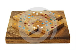 Wooden figures with color dots assemble in puzzle photo