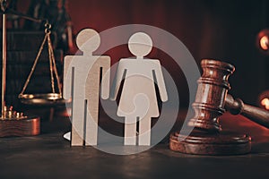 Wooden figures of people and gavel on a table close-up. Family law concept