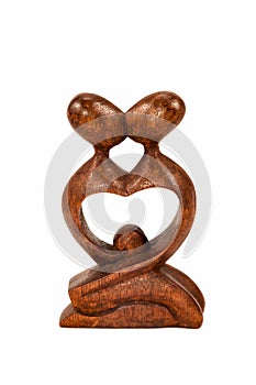 Wooden figures of people kissing couple