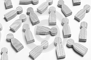 Wooden figures of people on a white background.