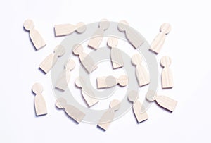 Wooden figures of people on a white background. The concept of s