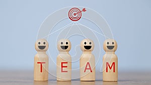 Wooden figures smile faces with team wording on the body and target icons. Teamwork and Ideas for business corporation concept.