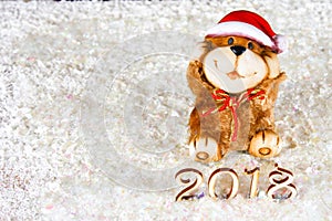Wooden figures of 2018 on snow. Christmas atmosphere. The new year 2018. A toy dog is a symbol of the New Year.