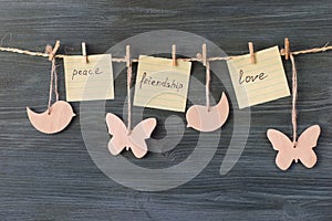 Wooden figures with the words: peace, friendship, love