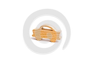 Wooden figurine of a car on a white background. Minimalism. The concept of car insurance, buying and selling cars.