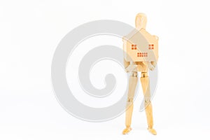Wooden figurines posed standing holding paper hpuse box on white