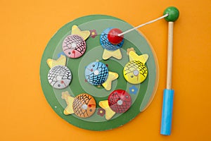 Wooden fishes and fishing rod with magnet on the tip.
