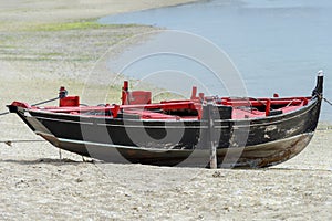 Wooden fishing boat dries ashore
