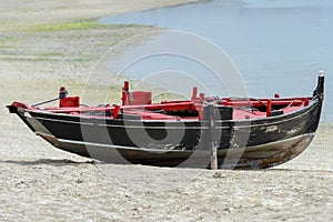 Wooden fishing boat dries ashore