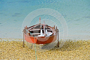 Wooden fishing boat dries on the seashore