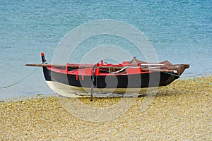 Wooden fishing boat dries up on the seashore