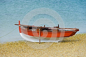 Wooden fishing boat dries up on the seashore