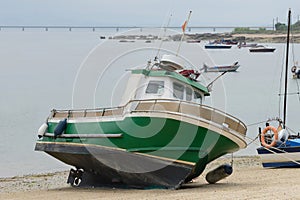 Wooden fishing boat is drying on the beach