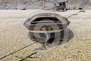 Wooden fishing boat is drying on the beach