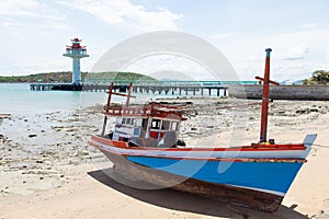 Wooden fishing boat moored on the beach.