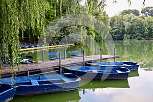 Wooden fishing boat in a still lake water