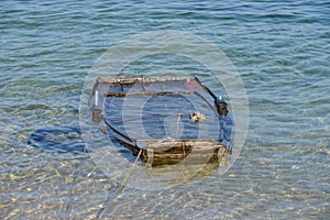 Wooden fishing boat submerged in water