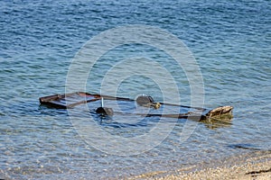 Wooden fishing boat submerged in water