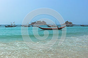 Wooden fishing boats in a small port. Beautiful landscape of sea, shore and boats. Tropical paradise turquoise water and
