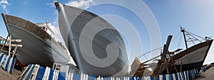 Wooden fishing boats under construction in shipyard, Morocco