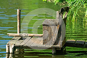 Wooden fishing jetty on a small forest lake