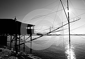 wooden fishing shed with huge nets on the sea