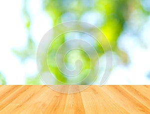 Wooden floor and abstract green bokeh background