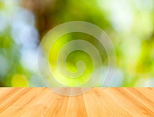 Wooden floor and abstract green bokeh background