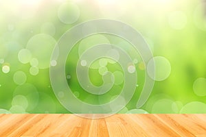 Wooden floor and abstract green bokeh background