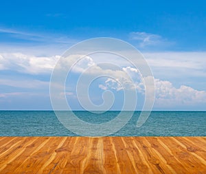 Wooden floor with blue sea and sky.