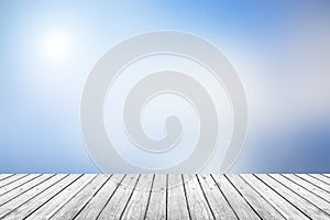 Wooden floor with blue sky blurred background