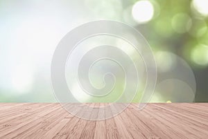 Wooden floor with blurred nature background of a view looking through the foliage