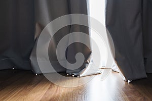 Wooden floor with bright sunlight through curtain in living room