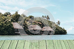 Wooden floor with bungalows on tropical island in the ocean can be used for display or montage your products