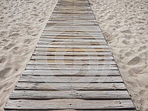 Wooden floor on golden sandy beach