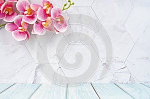 The Wooden floor and marble wall with pink color orchid decorate, empty room for background