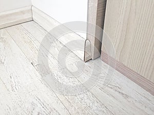 Wooden floor parquet with wooden baseboard