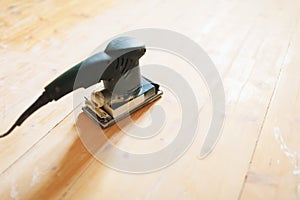 Wooden floor sanding with flat sander tool