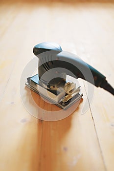 Wooden floor sanding with flat sander tool