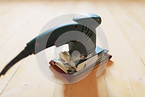 Wooden floor sanding with flat sander tool