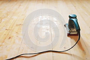 Wooden floor sanding with flat sander tool