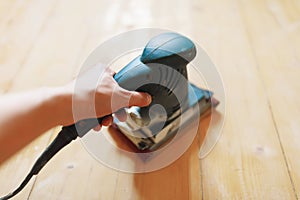 Wooden floor sanding with flat sander tool