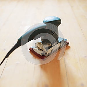 Wooden floor sanding with flat sander tool