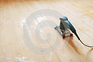 Wooden floor sanding with flat sander tool