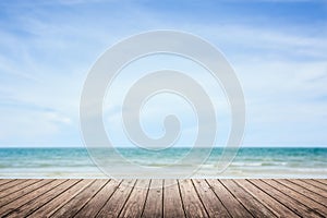 Wooden floor with sea and sky blurred background