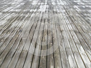 Wooden floor with small gap being covered with white frost