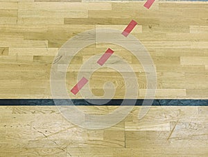 Wooden floor in sporting hall with solid and dotted lines. Light reflection